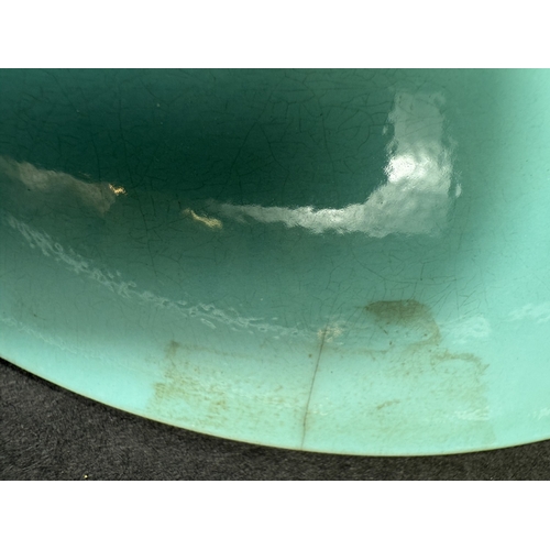 540B - A Chinese shallow dish decorated with central seated and robed figure, reading, turquoise outer rim ... 