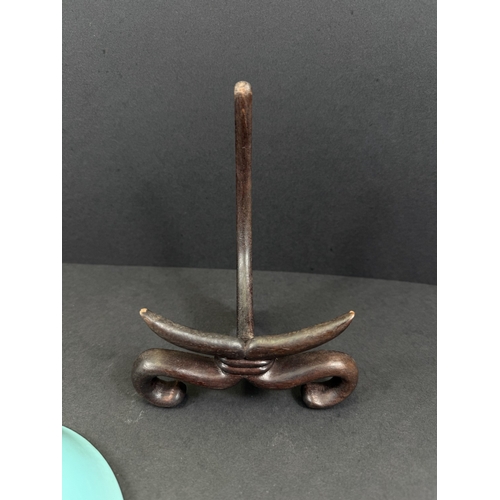 540B - A Chinese shallow dish decorated with central seated and robed figure, reading, turquoise outer rim ... 