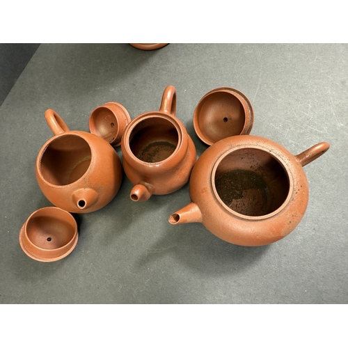 540E - Three Chinese traditional Yixing terracotta teapots; a similar Yixing terracotta baluster vase with ... 