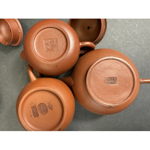 540E - Three Chinese traditional Yixing terracotta teapots; a similar Yixing terracotta baluster vase with ... 