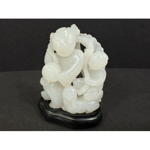 540G - An intricately carved and pierced Chinese white jade figure with child and dog, 64gm, ht 6cm, on woo... 
