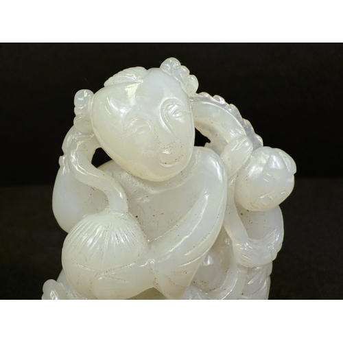 540G - An intricately carved and pierced Chinese white jade figure with child and dog, 64gm, ht 6cm, on woo... 