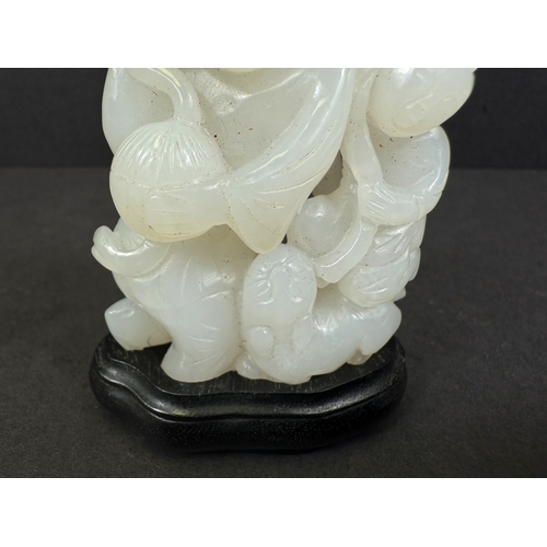 540G - An intricately carved and pierced Chinese white jade figure with child and dog, 64gm, ht 6cm, on woo... 