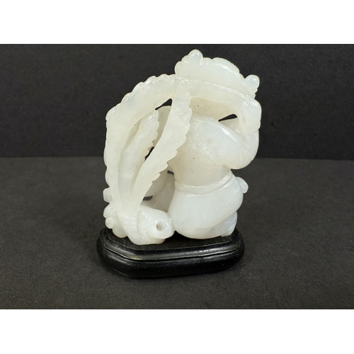 540G - An intricately carved and pierced Chinese white jade figure with child and dog, 64gm, ht 6cm, on woo... 
