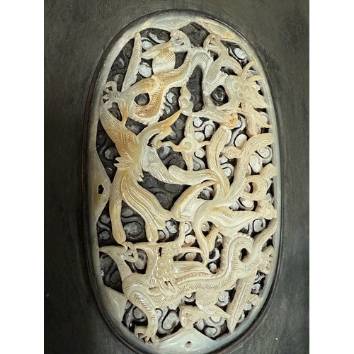 540L - An intricately carved and pierced Chinese oval jade panel in dark wood frame, panel length 14.5cm; 2... 