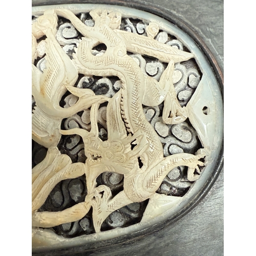 540L - An intricately carved and pierced Chinese oval jade panel in dark wood frame, panel length 14.5cm; 2... 