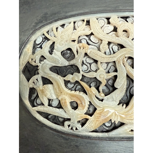 540L - An intricately carved and pierced Chinese oval jade panel in dark wood frame, panel length 14.5cm; 2... 