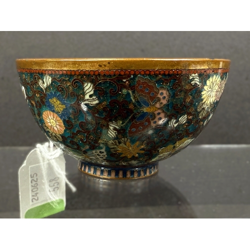 558 - A Japanese cloisonné tea bowl, late 19th century, finely decorated with butterflies on blue aventuri... 