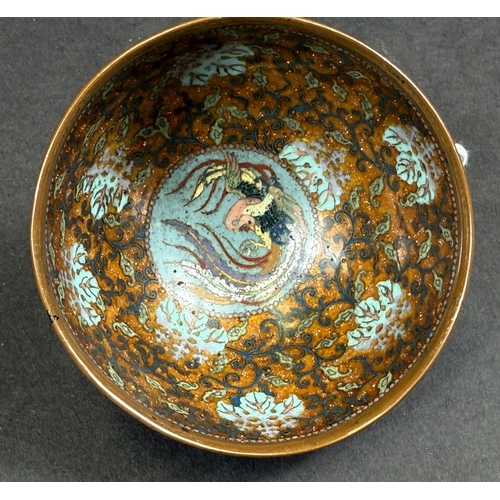 558 - A Japanese cloisonné tea bowl, late 19th century, finely decorated with butterflies on blue aventuri... 