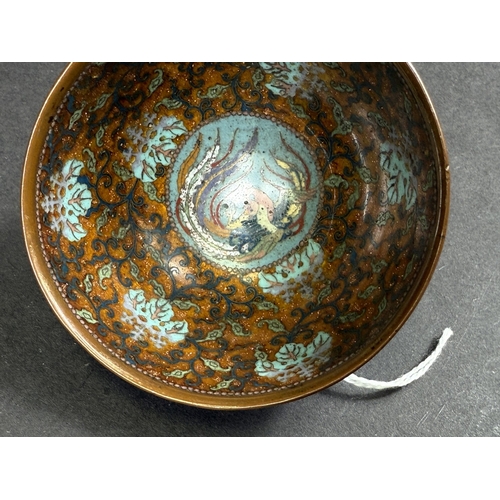 558 - A Japanese cloisonné tea bowl, late 19th century, finely decorated with butterflies on blue aventuri... 