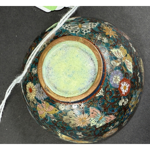 558 - A Japanese cloisonné tea bowl, late 19th century, finely decorated with butterflies on blue aventuri... 