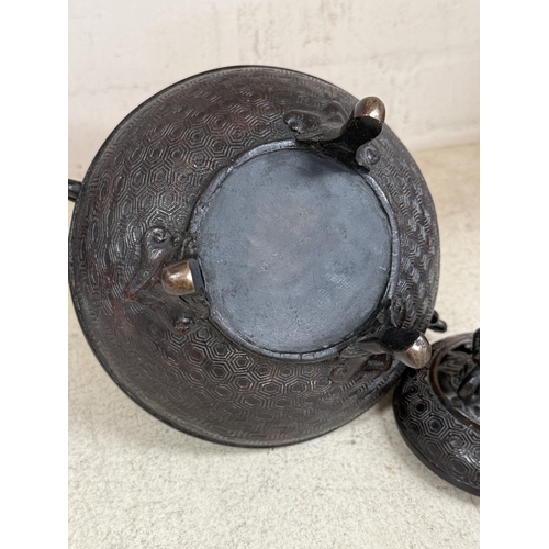 560 - A 19th century Chinese bronze incense burner of squat form carried on three legs, decorated in colou... 