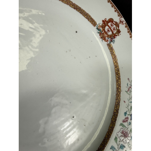 560C - An 18th century Chinese Yongzheng period armorial charger, the rim decorated with flowers and leaves... 
