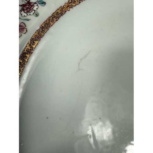 560C - An 18th century Chinese Yongzheng period armorial charger, the rim decorated with flowers and leaves... 