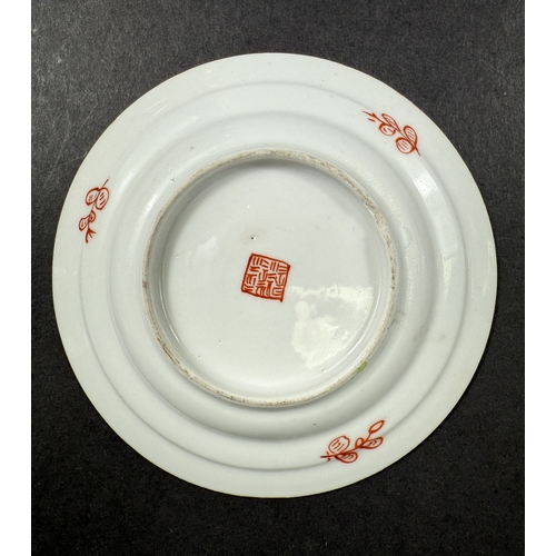 560D - A small 18th century Chinese 'Clobbered' dish, the central design with bird, flowers and trees on gr... 