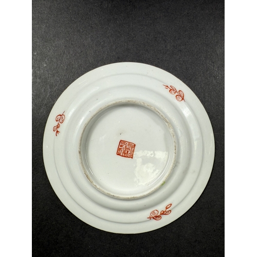 560D - A small 18th century Chinese 'Clobbered' dish, the central design with bird, flowers and trees on gr... 