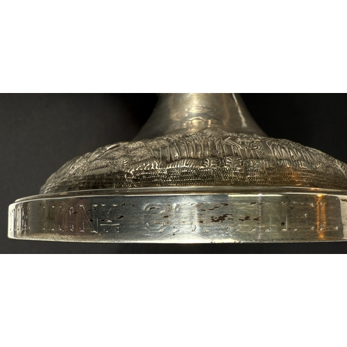 601 - A large late 19th century Indian white metal two-handled pedestal trophy cup with extensive relief d... 