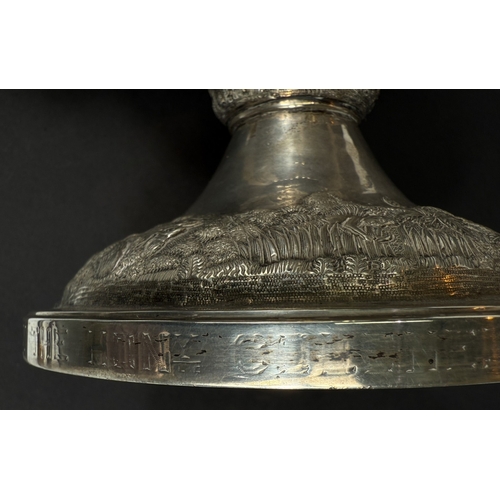 601 - A large late 19th century Indian white metal two-handled pedestal trophy cup with extensive relief d... 