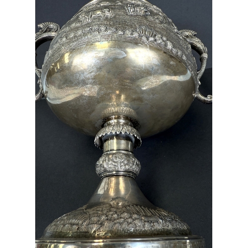 601 - A large late 19th century Indian white metal two-handled pedestal trophy cup with extensive relief d... 