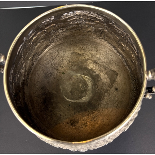 601 - A large late 19th century Indian white metal two-handled pedestal trophy cup with extensive relief d... 