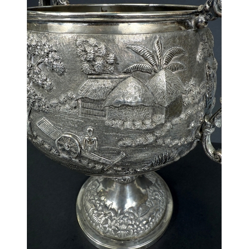 601 - A large late 19th century Indian white metal two-handled pedestal trophy cup with extensive relief d... 
