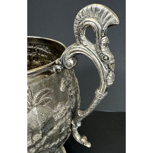 601 - A large late 19th century Indian white metal two-handled pedestal trophy cup with extensive relief d... 
