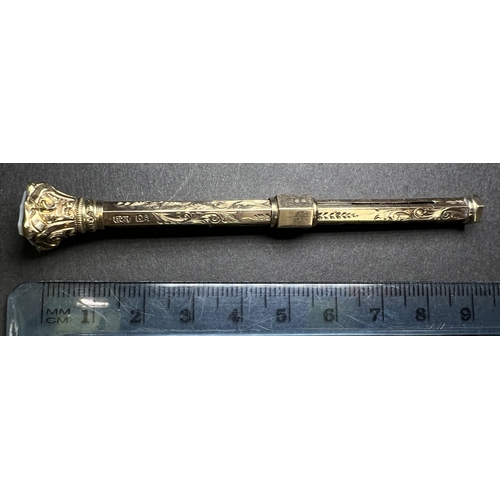 631 - A yellow metal chased and engraved propelling pencil with seal top, stamped 