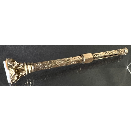 631 - A yellow metal chased and engraved propelling pencil with seal top, stamped 