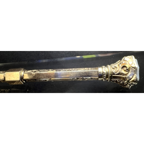 631 - A yellow metal chased and engraved propelling pencil with seal top, stamped 