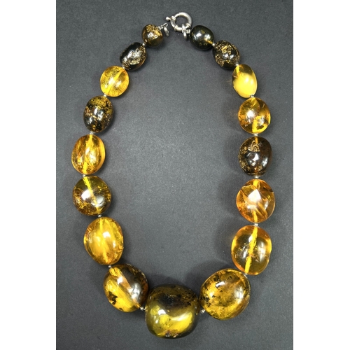 632 - A necklace formed from large graduating amber beads in a range of colours, weight 93gm, length overa... 