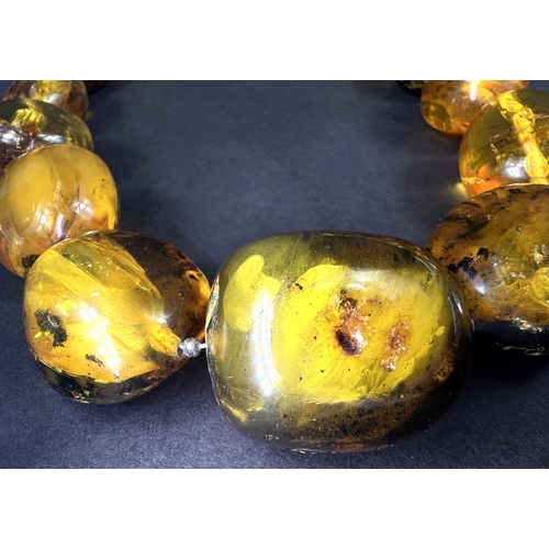 632 - A necklace formed from large graduating amber beads in a range of colours, weight 93gm, length overa... 