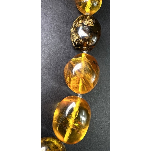 632 - A necklace formed from large graduating amber beads in a range of colours, weight 93gm, length overa... 