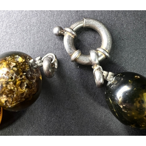 632 - A necklace formed from large graduating amber beads in a range of colours, weight 93gm, length overa... 