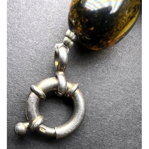 632 - A necklace formed from large graduating amber beads in a range of colours, weight 93gm, length overa... 