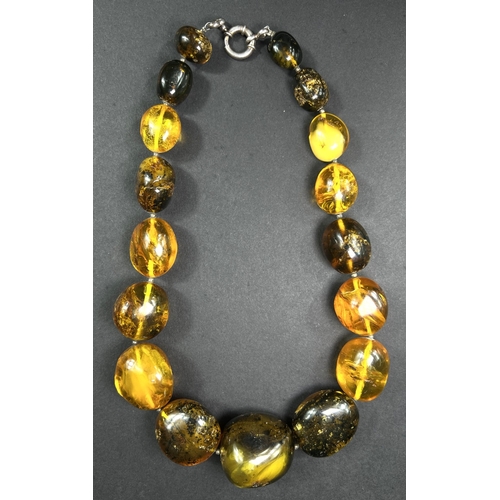632 - A necklace formed from large graduating amber beads in a range of colours, weight 93gm, length overa... 