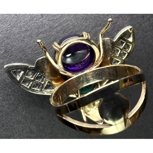 633 - An unusual yellow metal dress ring in the form of a fly, the body formed from a cabochon emerald and... 