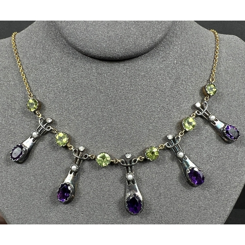 634 - An Art Nouveau style yellow metal necklace with 5 drops each set with an oval amethyst and seed pear... 
