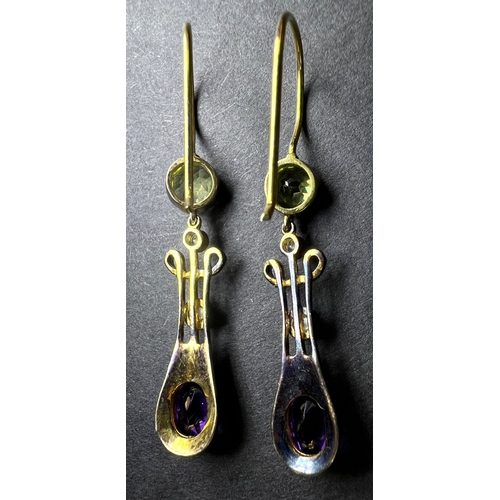 635 - A pair of Art Nouveau yellow metal earrings to match lot 634, set circular peridot with drop having ... 