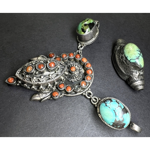 637 - An Eastern white metal pendant set with coral coloured stones, drops etc and a similar bead