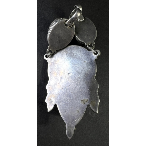 637 - An Eastern white metal pendant set with coral coloured stones, drops etc and a similar bead