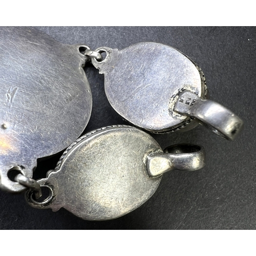 637 - An Eastern white metal pendant set with coral coloured stones, drops etc and a similar bead