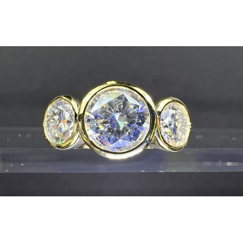 689 - A modern dress ring with 3 large moissanite stones (approx. 4ct total) in gold plated setting stampe... 