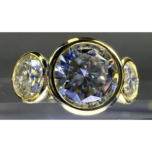 689 - A modern dress ring with 3 large moissanite stones (approx. 4ct total) in gold plated setting stampe... 