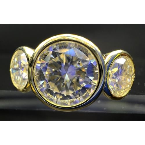 689 - A modern dress ring with 3 large moissanite stones (approx. 4ct total) in gold plated setting stampe... 