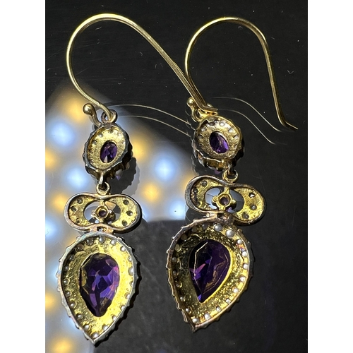 691 - A pair of Victorian style pendant earrings set with pear shape amethyst and seed pearls to lower dro... 