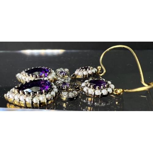 691 - A pair of Victorian style pendant earrings set with pear shape amethyst and seed pearls to lower dro... 