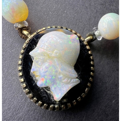 694 - An opal and crystal necklace formed fom a row of round opal beads spaced by faceted crystal rondelle... 