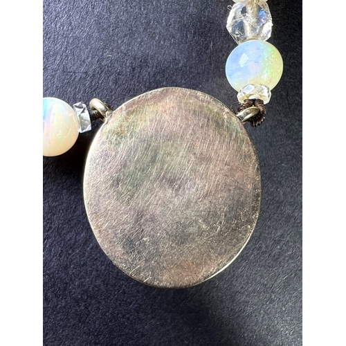 694 - An opal and crystal necklace formed fom a row of round opal beads spaced by faceted crystal rondelle... 