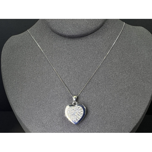 699 - A 9ct gold heart shaped locket set with crystals on chain