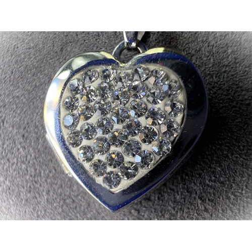 699 - A 9ct gold heart shaped locket set with crystals on chain